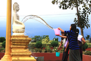 Pouring water on Buddha Statue