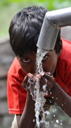 Child drinking water from handpump in Madhya Pradesh