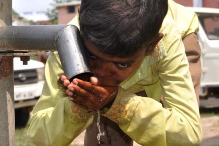 Child drinking water near Gwalior in Madhya Pradesh