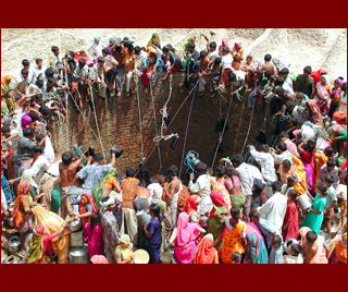 Thirsty earth: Indian villagers in Gujarat gather to draw water from a well