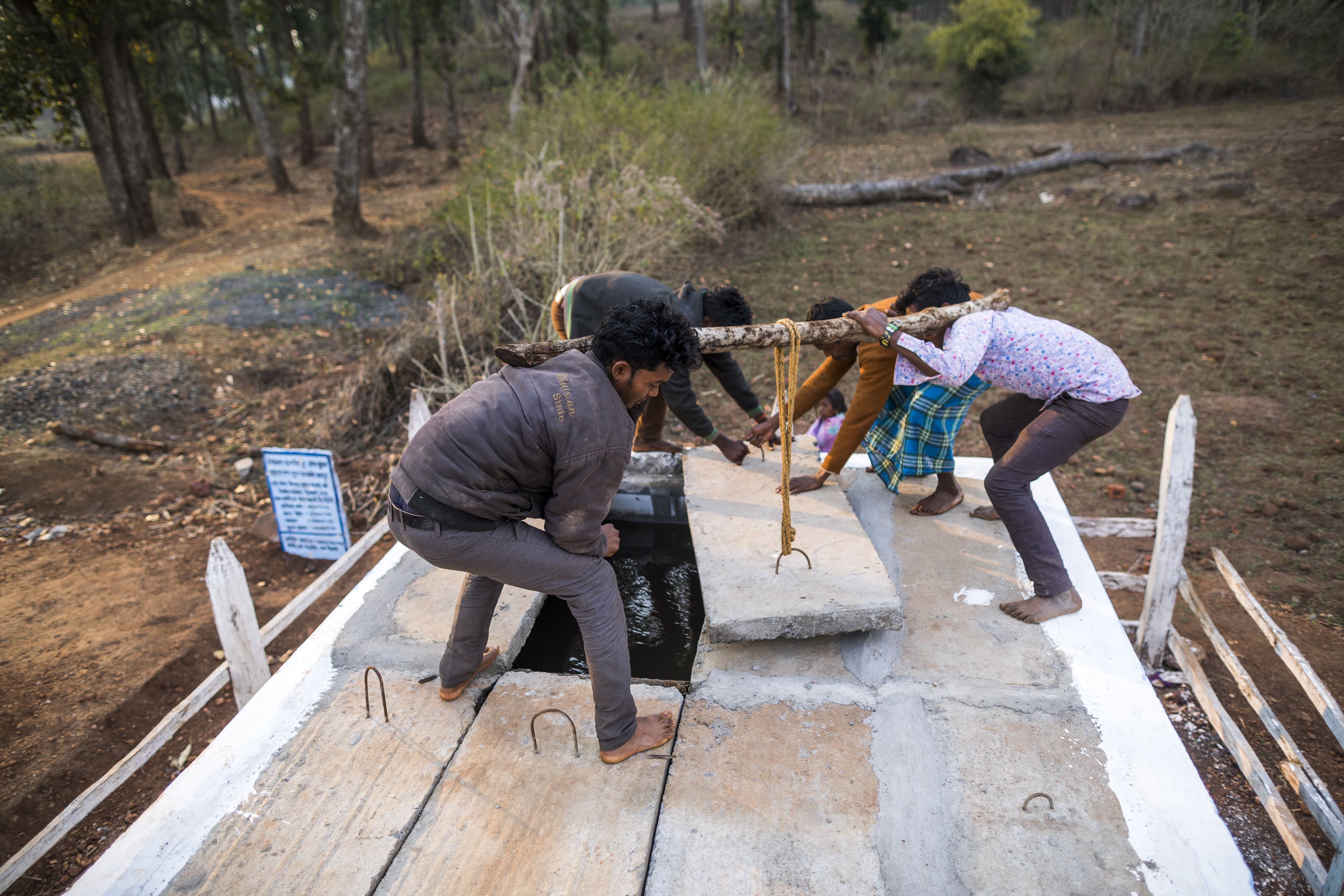 People gather to inspect a stand post