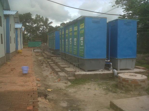 Array of portable bio-toilets in labour colony at construction site