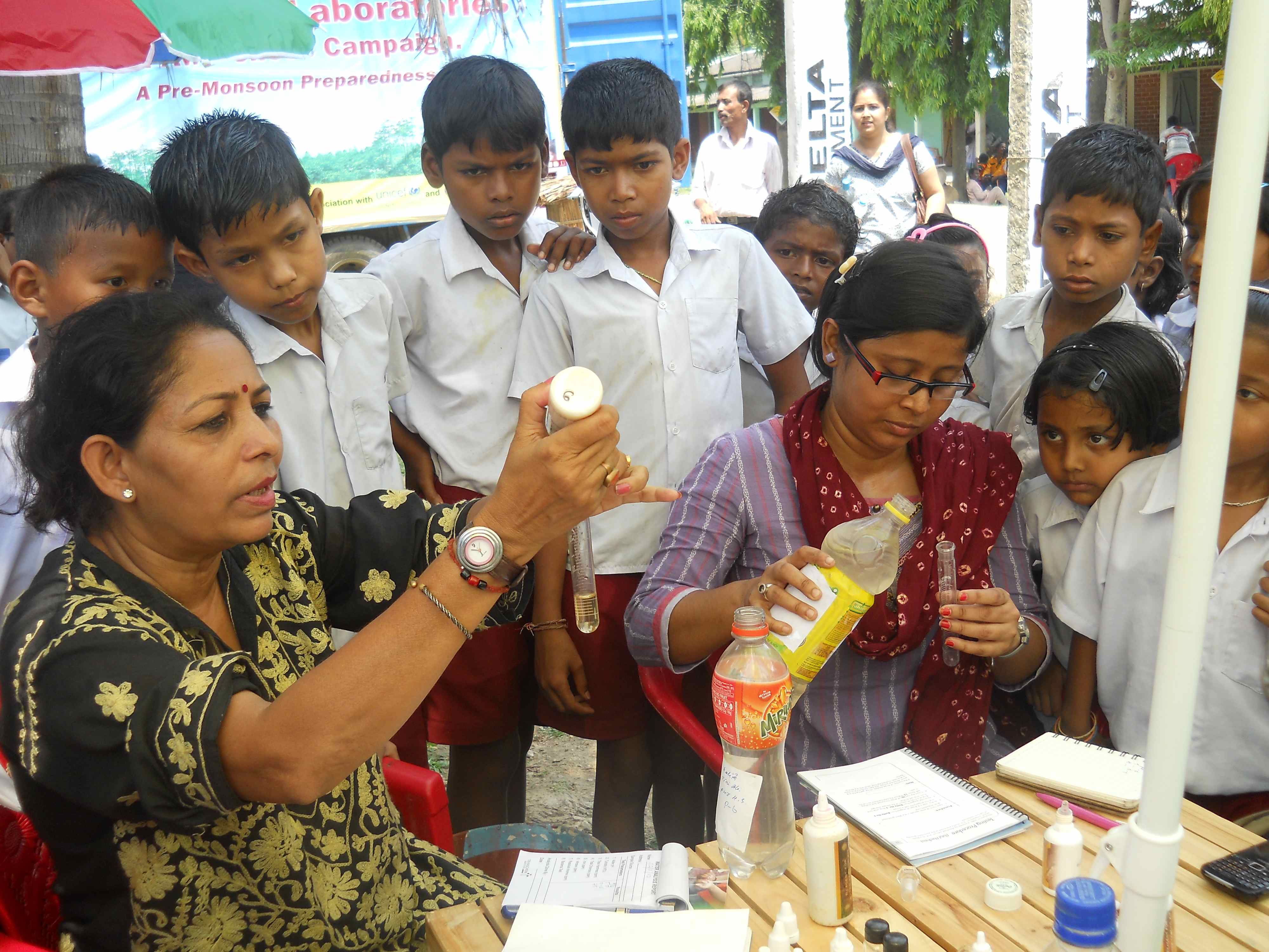 School children gather around a testing unit at Chandrapur , Kamrup district
