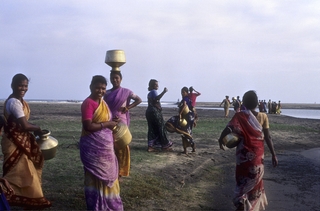 Poompuhar, Ladies collecting water as the  cauvery river reaches the sea 