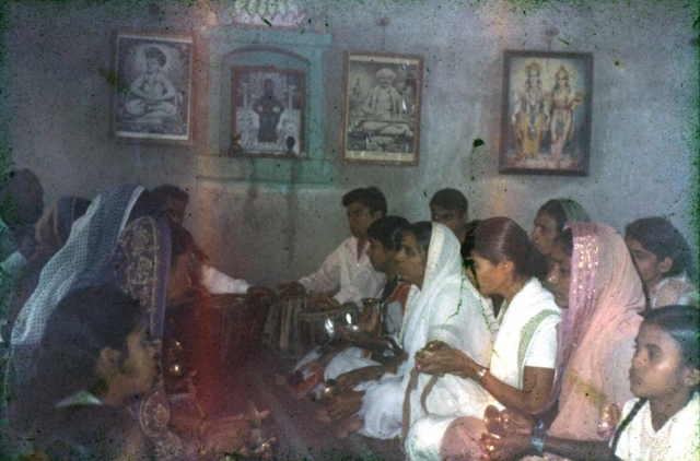 A group of people singing kirtans