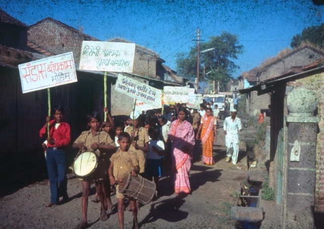 village procession with children beating drums