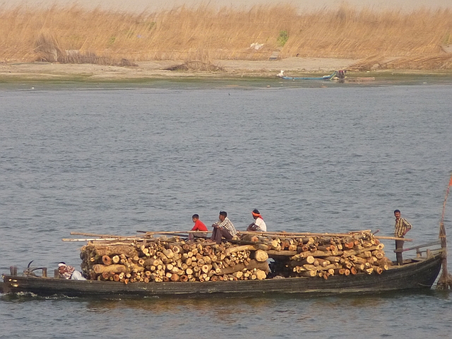 Boat carrying timber to the burning ghats of Varanasi