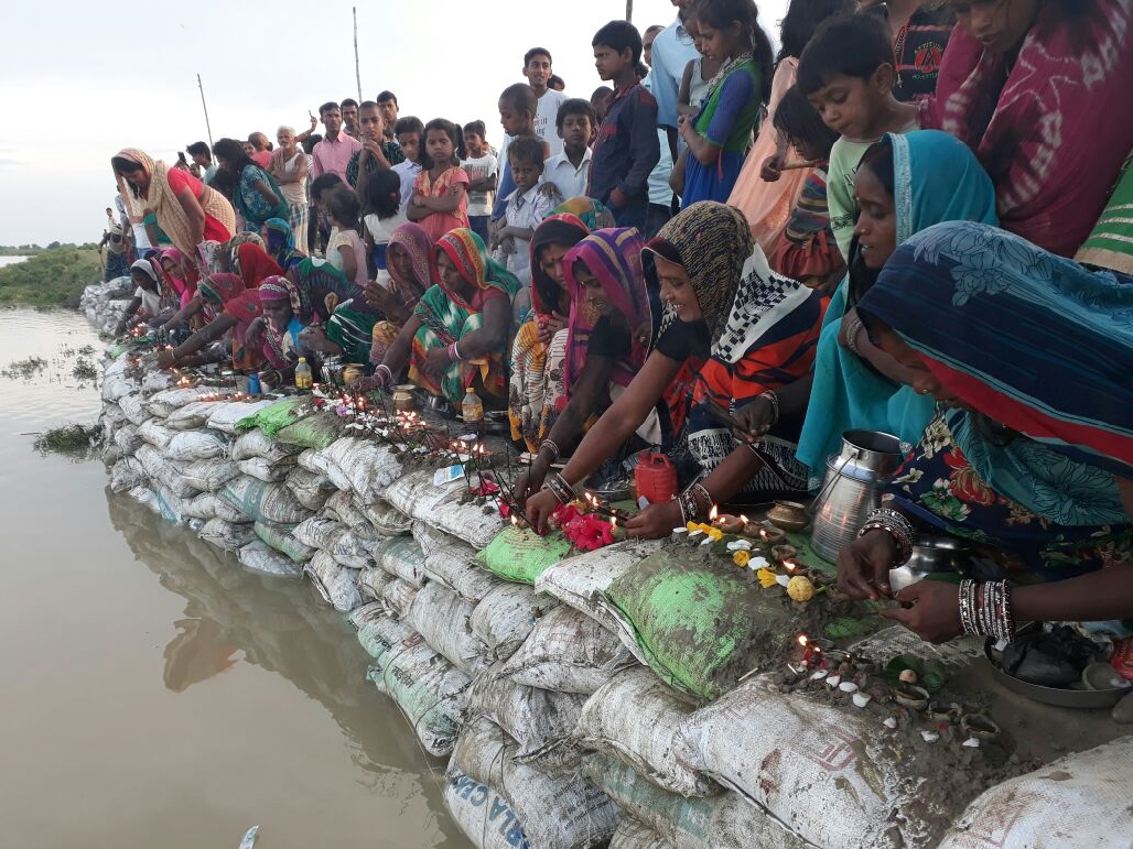 Women in Khagaria village in Bihar offer prayers to bring the flood situation under control. (Photo by Ritesh Kumar)