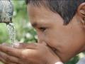A school boy from Tilonia drinks from a tap from a rainwater harvesting tank (Image: Barefoot photographers of Tilonia)