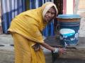 Meenadevi driking water from the low cost filter (Image Source: Sehgal Foundation)