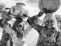 Women carrying water in Rajasthan (Image Source: Christopher Michel via Wikimedia Commons)