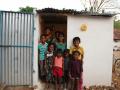 Children pose outside a toilet (Image: India Water Portal Flickr)