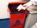 A lab technician discarding disposable gloves (Image: CDC/Kimberly Smith, Christine Ford acquired from Public Health Image Library)