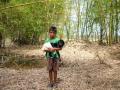 The Amphan swept away the chicken coops and other domestic animals. This is Anup Bhakta standing with one of the few goats left after the storm. (Image: WaterAid, Subhrajit Sen)