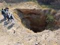 A study group observing groundwater in a well