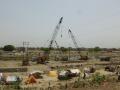 Earth movers cluster on the riverbed of the Gomti, engaged in channelizing the river