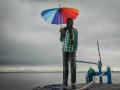 A boatman looks at the vast and furious Brahmaputra