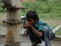 A child drinks water from a hand pump in Madhya Pradesh. (Source: IWP Flickr Photos)