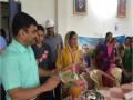 Sudam Khade, collector, Sehore, felicitates a woman from the community for their efforts in ending open defecation.