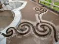 An intricate set of curlicues set in the floor leads rainwater from the roofs to a tank in Jahaz Mahal, Mandu