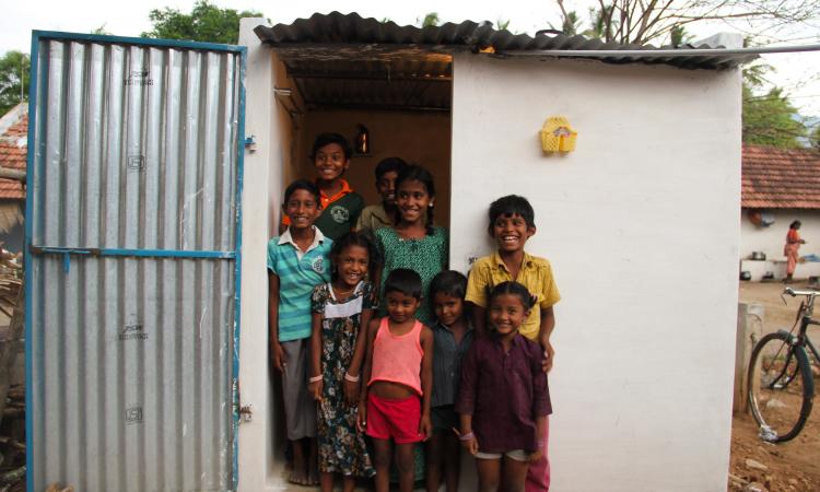 Children pose outside a toilet (Image: India Water Portal Flickr)