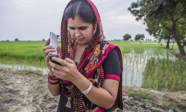 Ruby Mehla, a farmer recieves regular updates on weather and climate smart practices through voice messages on their registered mobile phone in the Climate Smart Village of Anjanthalli. (Image: CCAFS/2014/Prashanth Vishwanathan)