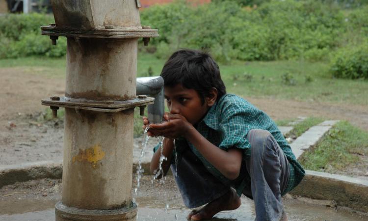 Child drinking water from handpump in Guna, Madhya Pradesh (Image: Anil Gulati, India Water Portal Flickr)