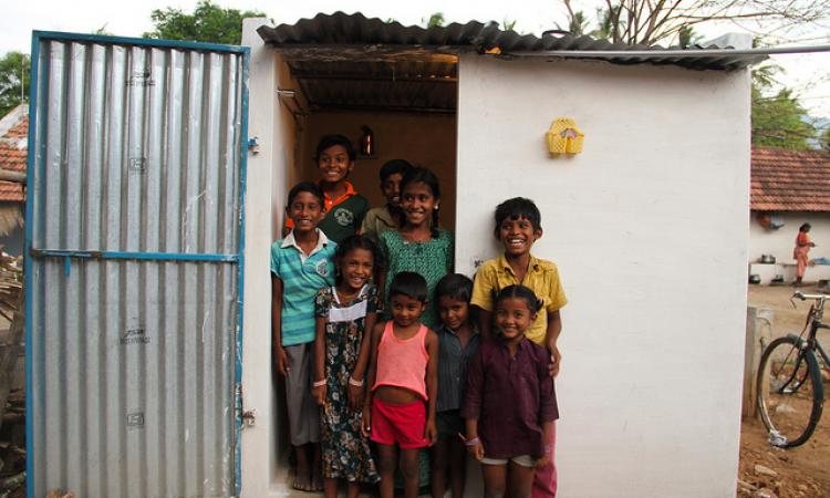 Children pose outside a toilet in Sanarpudur village, Namakkal.