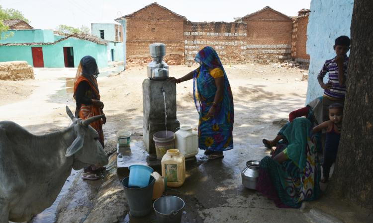 Women fill water from one of the taps at Pipara.