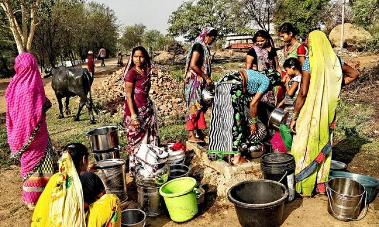 Collecting water, a daily backbreaking task of women. (Image Source: India Water Portal)