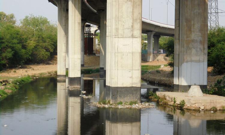 Construction debris of the Barapullah flyover project chokes the nallah.