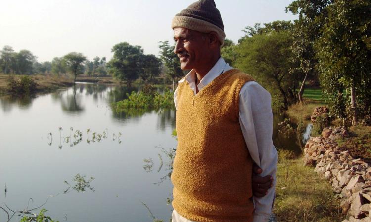 Farmer looks at the water conservation efforts