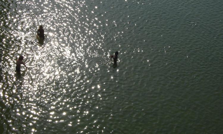 Boys wait to collect coins thrown into the Ganga at Kanchla, Uttar Pradesh.