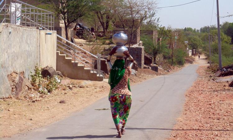 Village women collect water for toilet use. (Photo by India Water Portal)