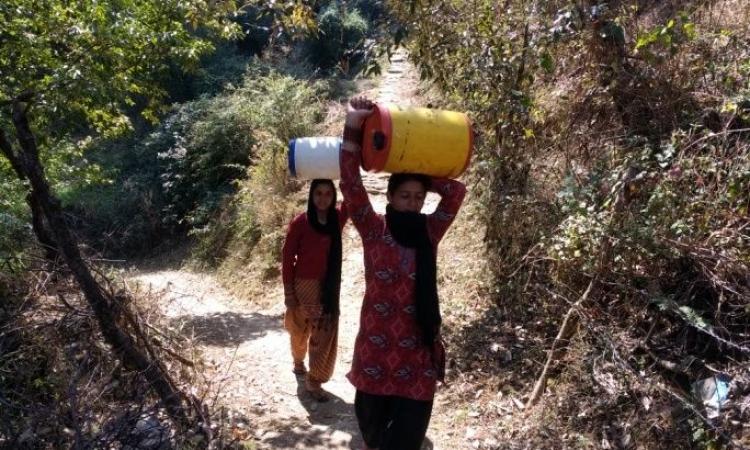 Women trudged long distances daily to fetch water for their basic household needs in Rupail (Image: People's Science Institute)