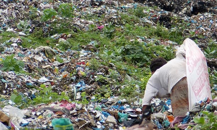 A ragpicker sorts through garbage