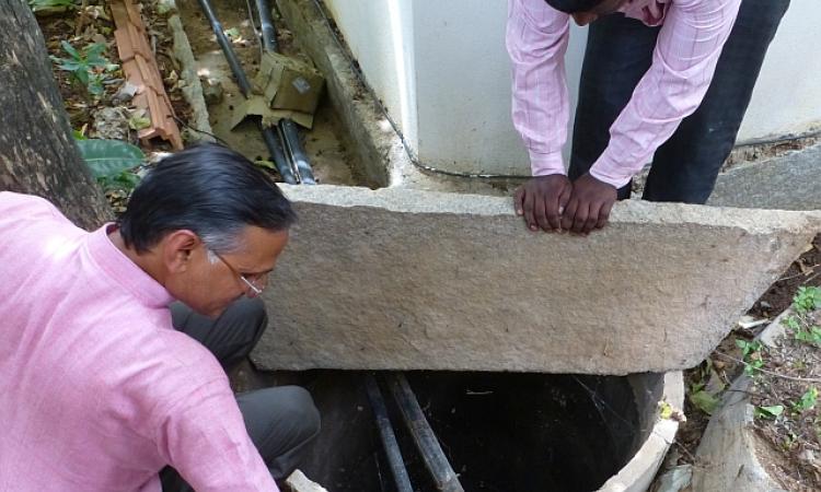 K.P. Singh shows one of the recharge wells 