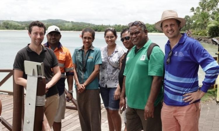 Dr Mitchel Harley (far right) at the installation of a CoastSnap station in Fiji. Photo credit: Navneet Lal