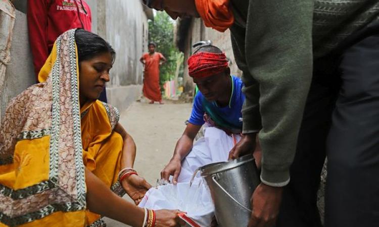 Shantilata uses a cloth to filter out the high iron content in the salty water, filled from a hand pump, in the village Sitapur on the outskirts of Bhadrak, Bhuvaneshwar, Odisha (Image: WaterAid/ Anindito Mukherjee)